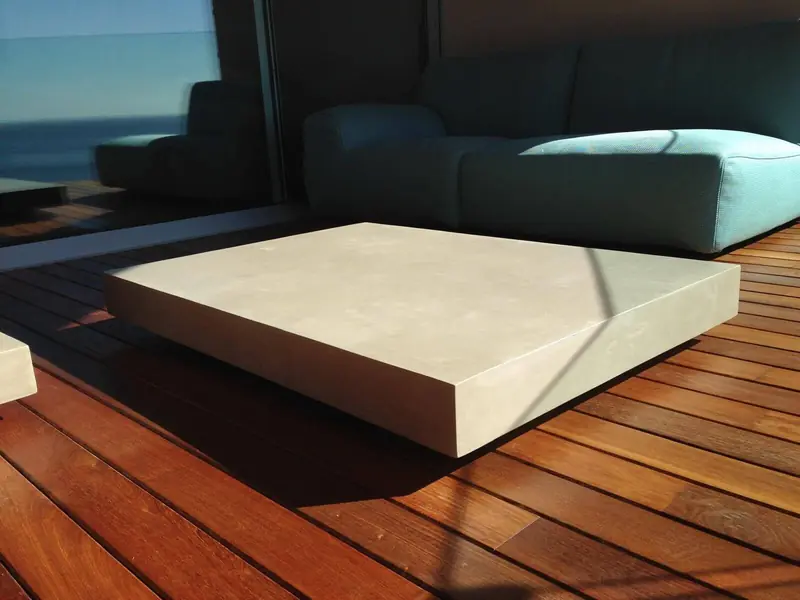 Mesa de centro de microcemento sobre tarima de madera con vistas al mar